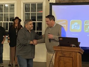 David Lowitz accepts the award from Chief Revenue Officer Scott Chuhinko